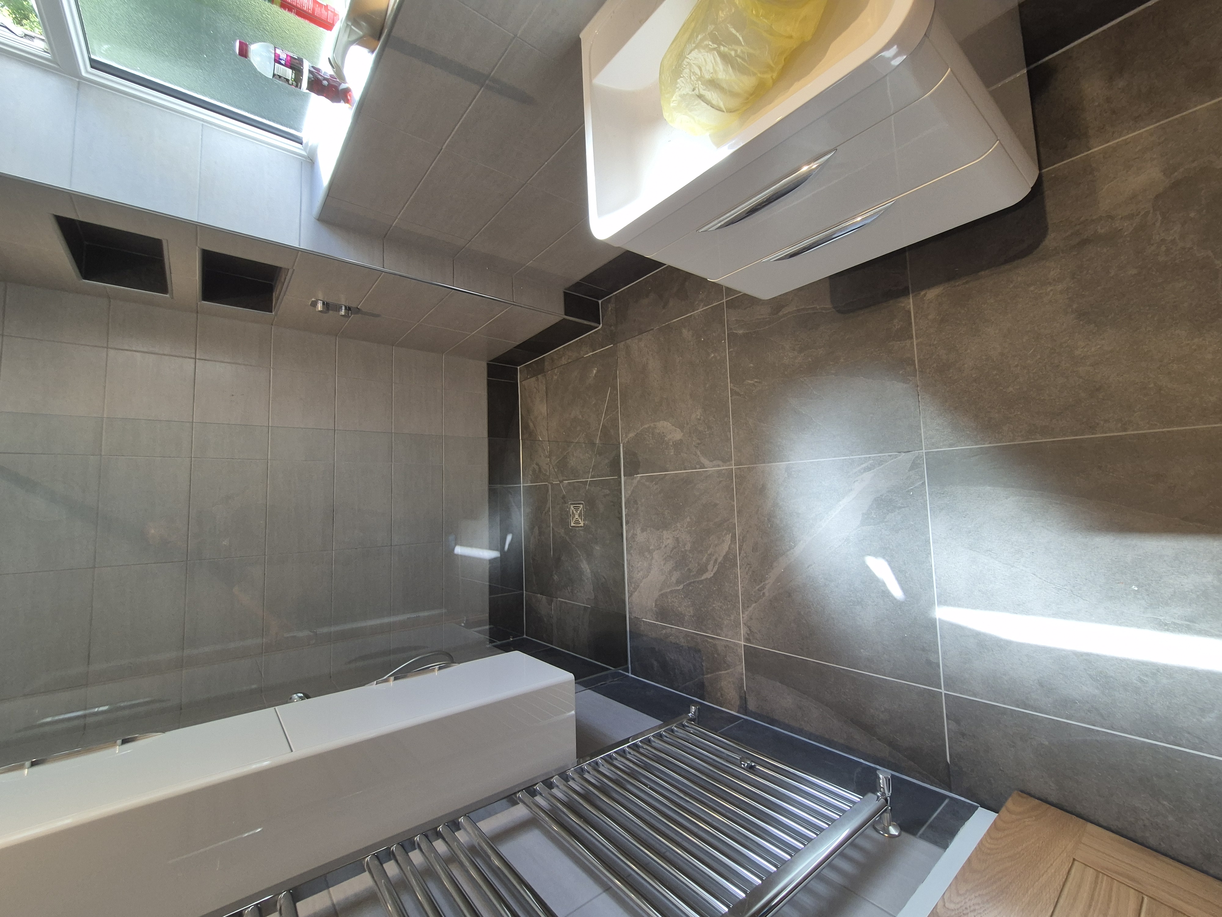 Completed wet room floor viewed from the doorway after remedial works
